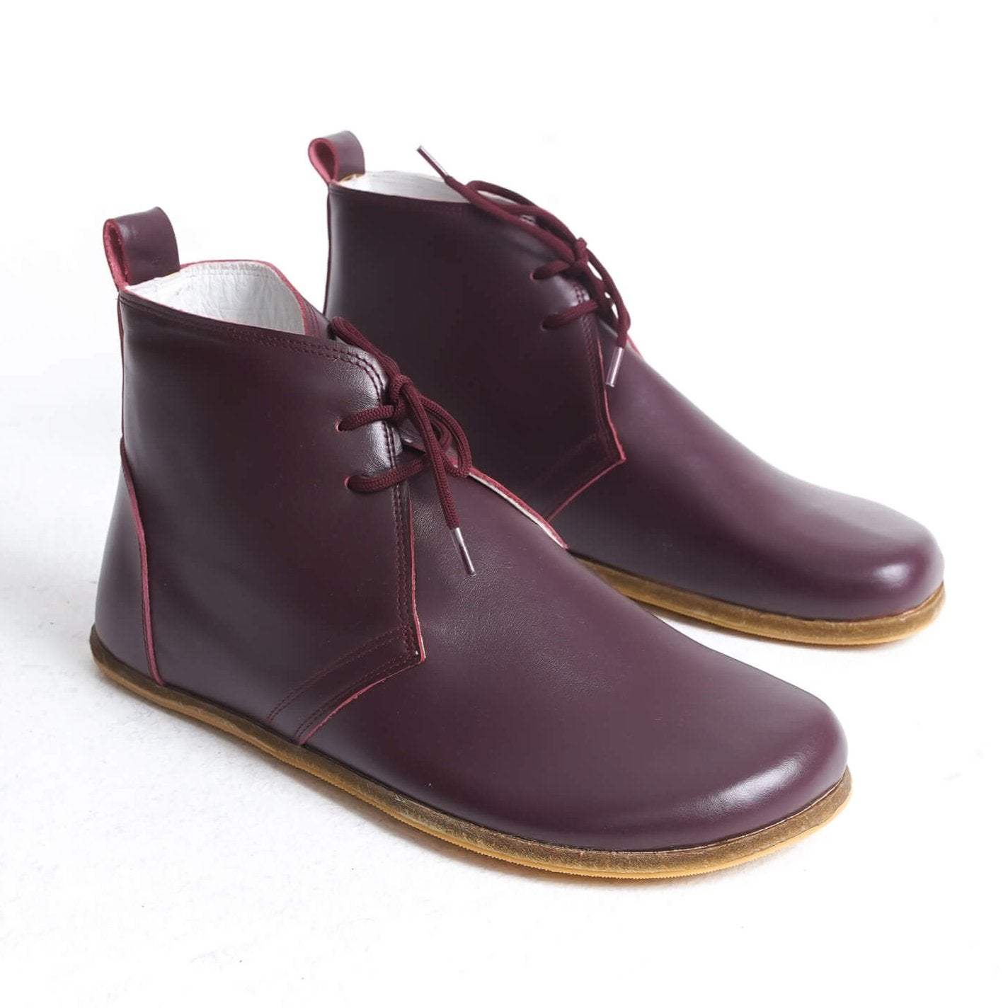 Minimalist burgundy leather barefoot boots with zero-drop sole, designed for natural movement and everyday comfort – ideal for US customers.