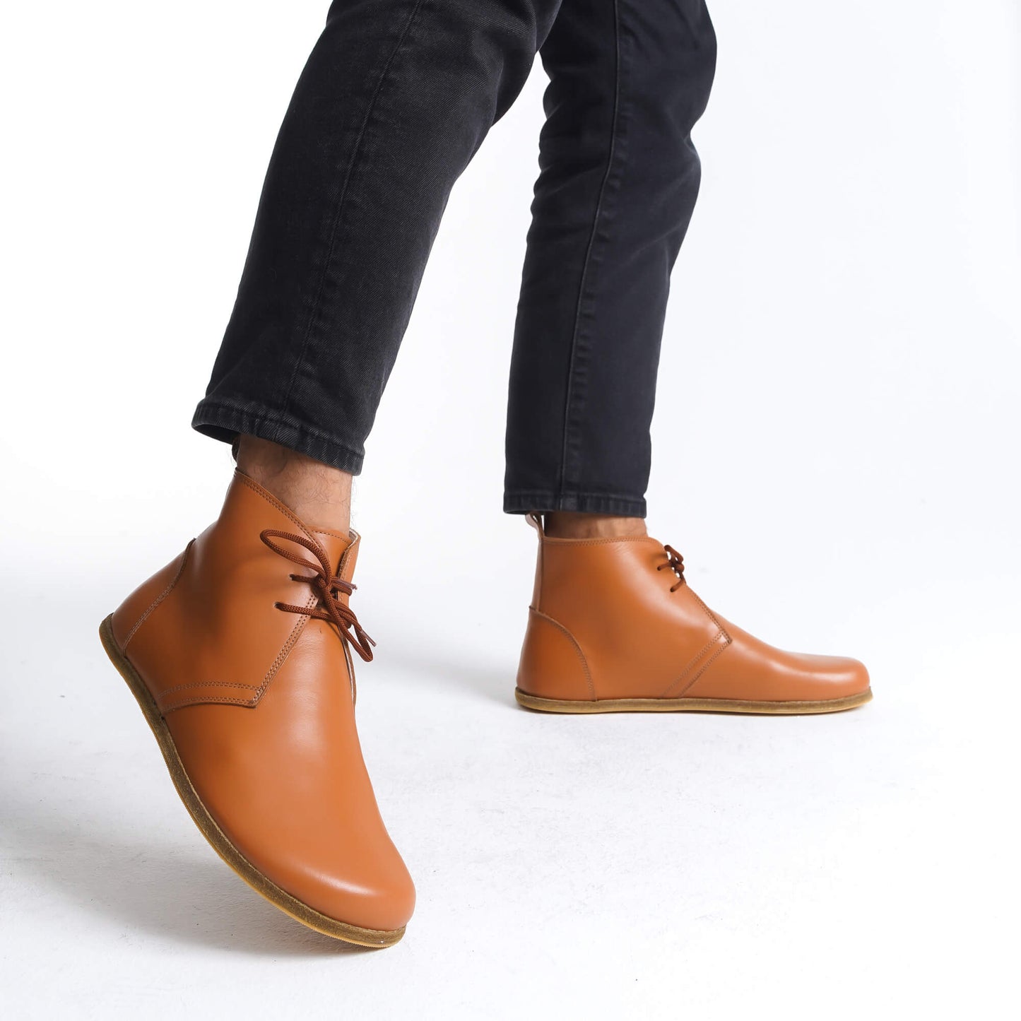 Support your feet in comfort and style with our wide-toe box, tan leather boots. Designed for natural foot movement.