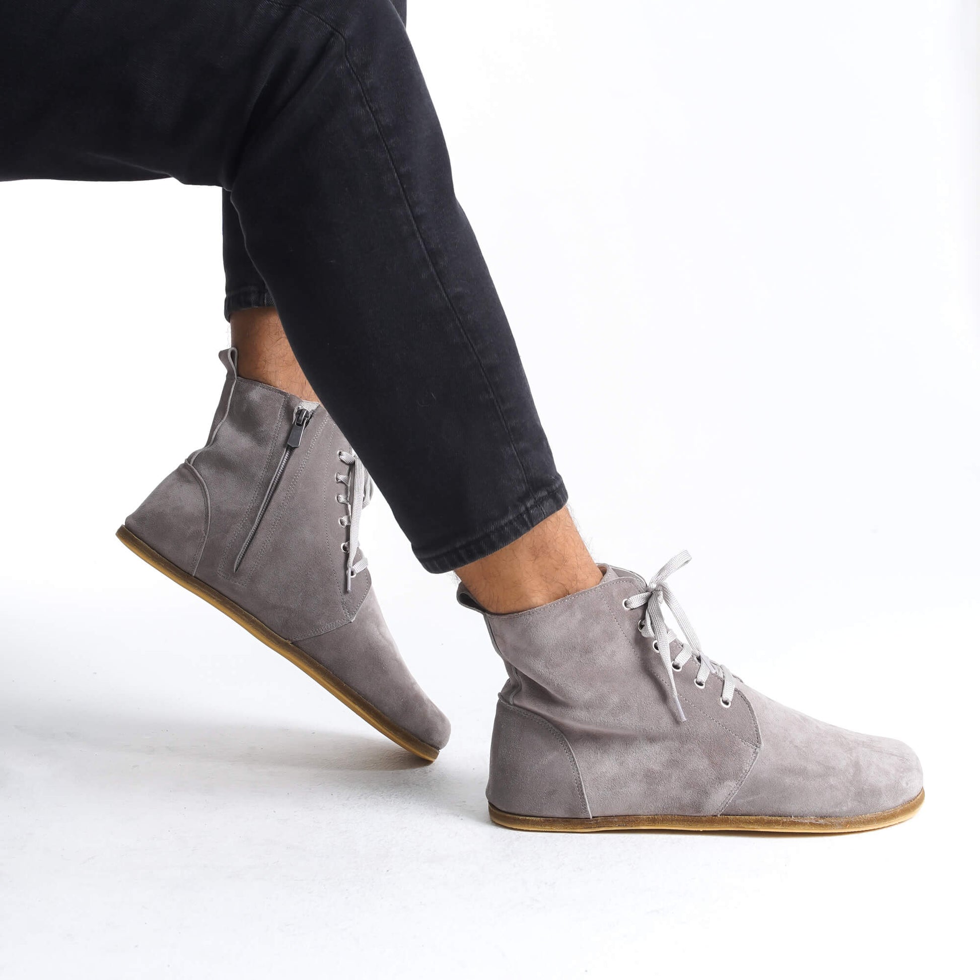 Elegant gray barefoot winter boots that effortlessly blend with any outfit. Featuring a minimalist design and flexible sole, they ensure your feet stay warm and comfortable throughout the colder months.