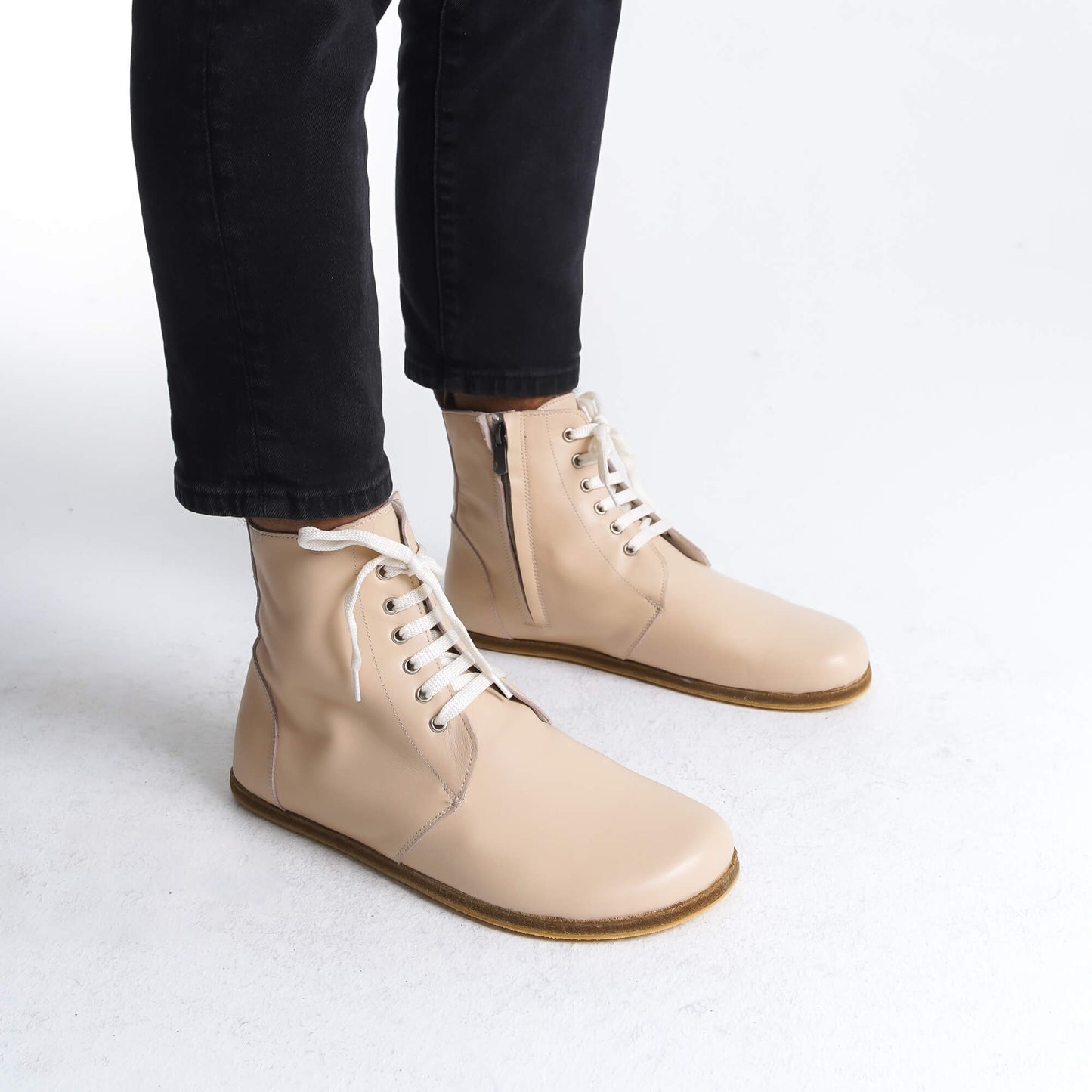 "Cream barefoot winter boots designed for optimal foot health. Featuring a breathable upper and zero-drop sole, these boots are ideal for both style and comfort during winter months.