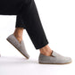 Comfortable Gray suede Aeolia Leather Barefoot Men's Loafers, shown on feet with black pants for a sleek and versatile look.