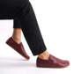 Side view of Ionia Leather Barefoot Men Loafers in Burgundy, worn with black pants, highlighting the natural foot shape design.
