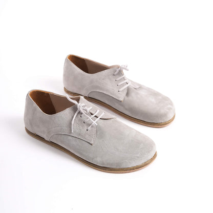Locris Leather Barefoot Men's Oxfords in gray suede, displayed side by side, highlighting their soft texture and minimalist design.