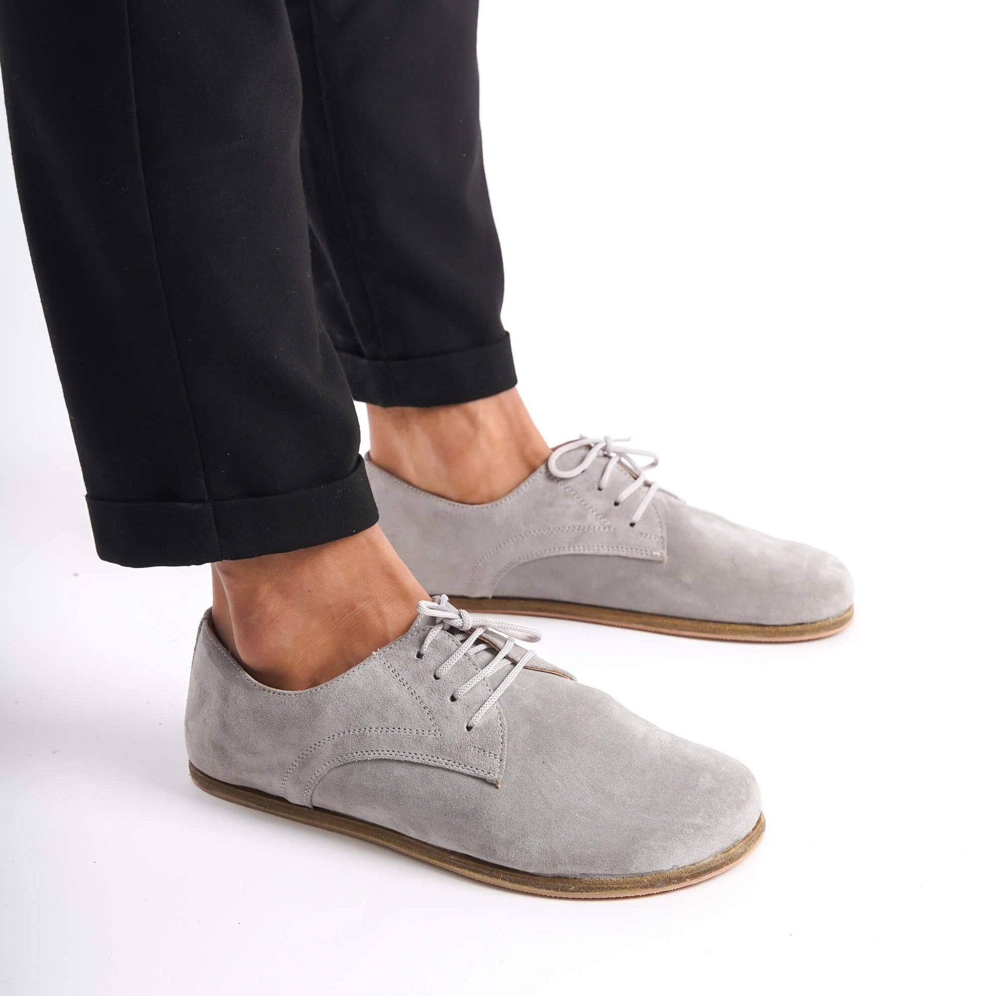 Top-down view of Locris Leather Barefoot Men's Oxfords in gray suede, paired with gray socks, emphasizing their unique style.