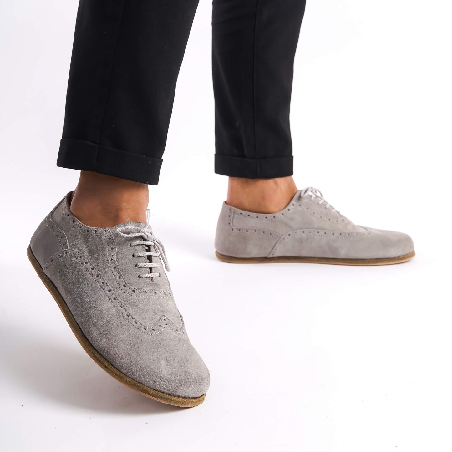 Gray suede barefoot Oxfords on a man, demonstrating the natural fit and comfort of the shoes.