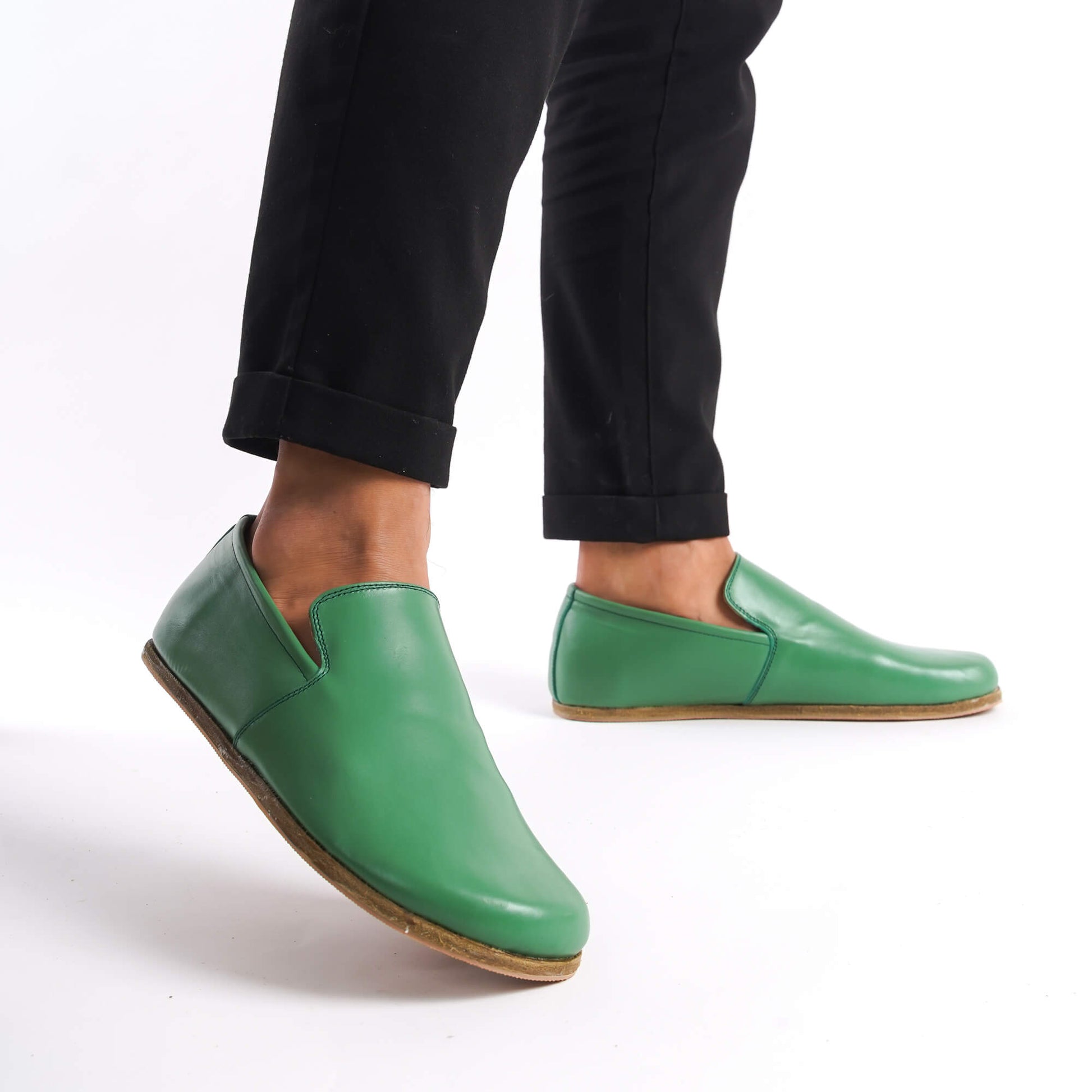 Side view of Green Aeolia Leather Barefoot Men's Loafers, worn with black pants, perfect for a versatile and comfortable look.