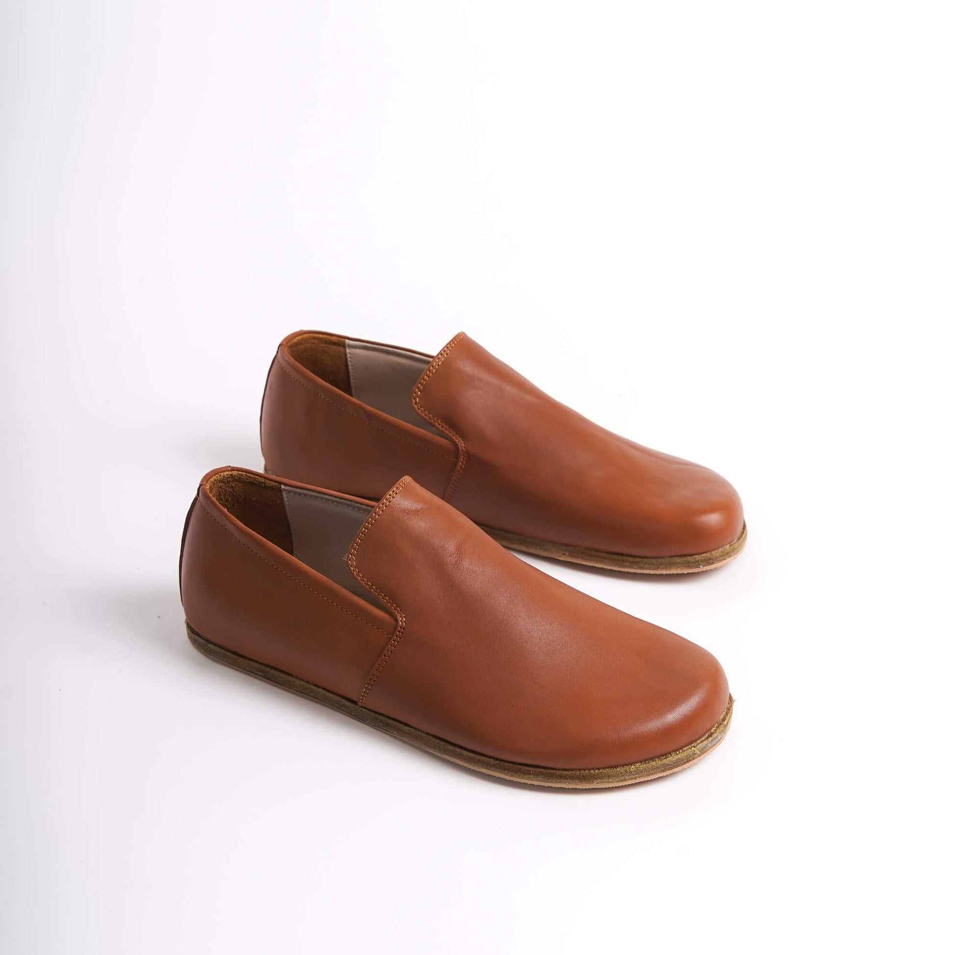 Tan brown Aeolia Leather Barefoot Men's Loafers with a wide toe box and minimalist design, perfect for comfort and style.