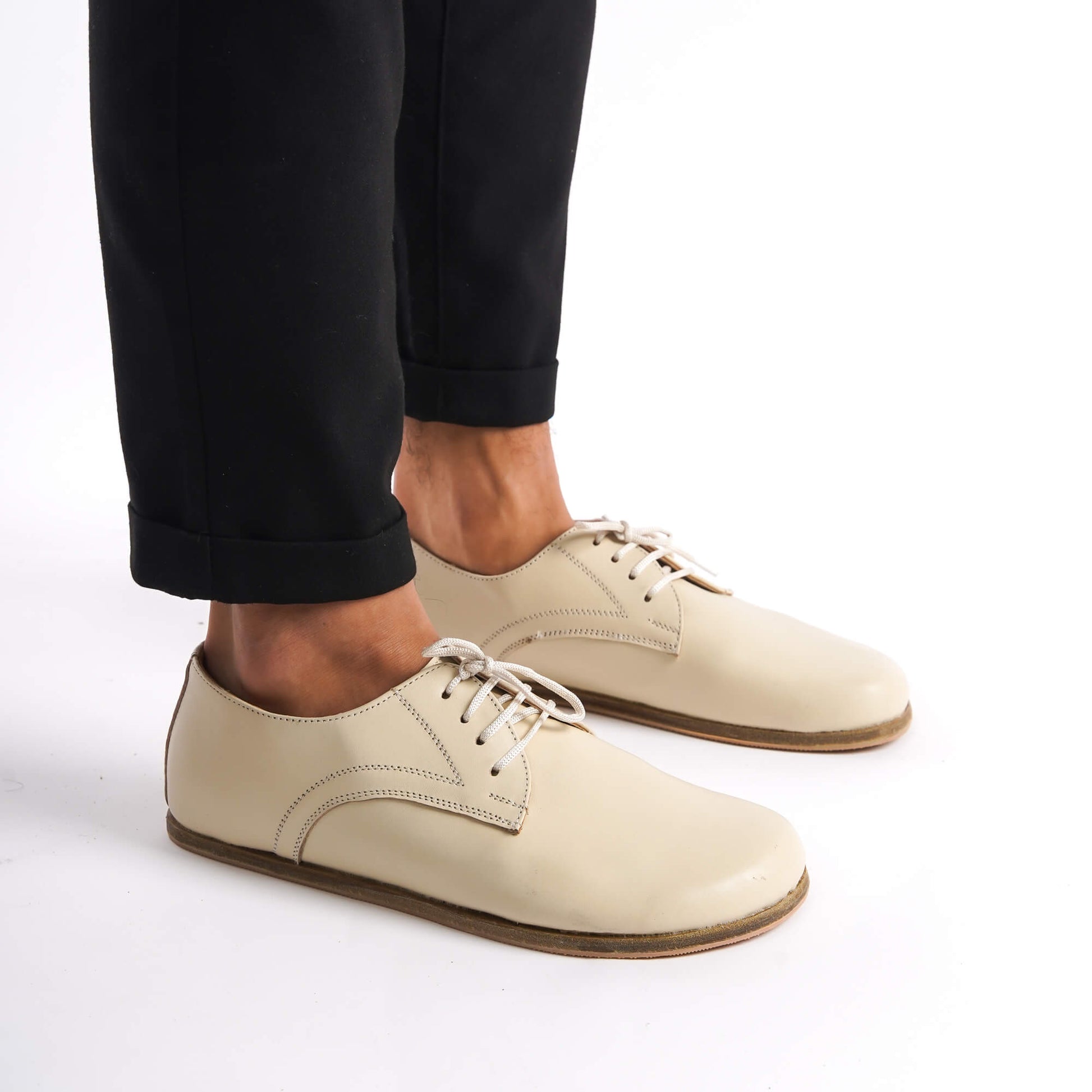 Stylish beige Locris barefoot Oxfords paired with black pants – versatile, modern, and comfortable footwear.