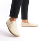 Front view of Ionia Leather Barefoot Men Loafers in beige on a model, with black pants rolled up to show the shoes' detail.