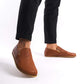 Stylish tan brown Ionia leather loafers for men with black pants, showcasing genuine leather and zero-drop design, buy now at pelanir.com.