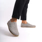 Close-up side view of gray suede barefoot men's loafers by Pelanir, highlighting the flexible sole and natural fit.