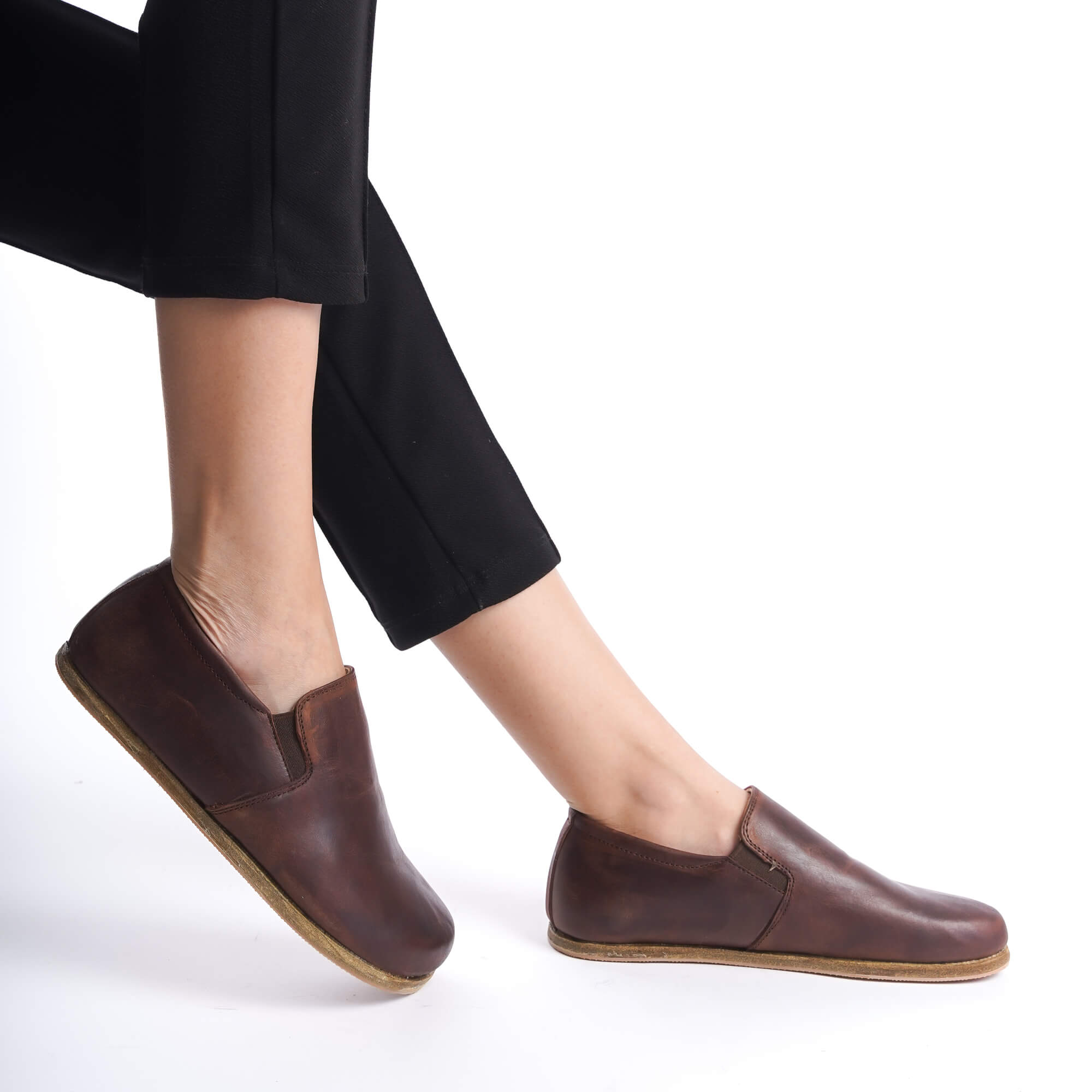 Ionia Leather Barefoot Women Loafers in brown, shown in mid-step, highlighting the minimalist design.