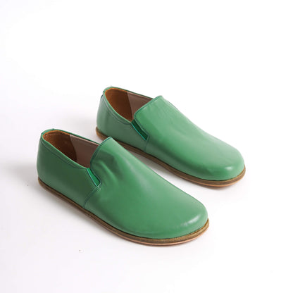 Green Ionia leather barefoot loafers with natural sole on white background. Shop now at pelanir.com!