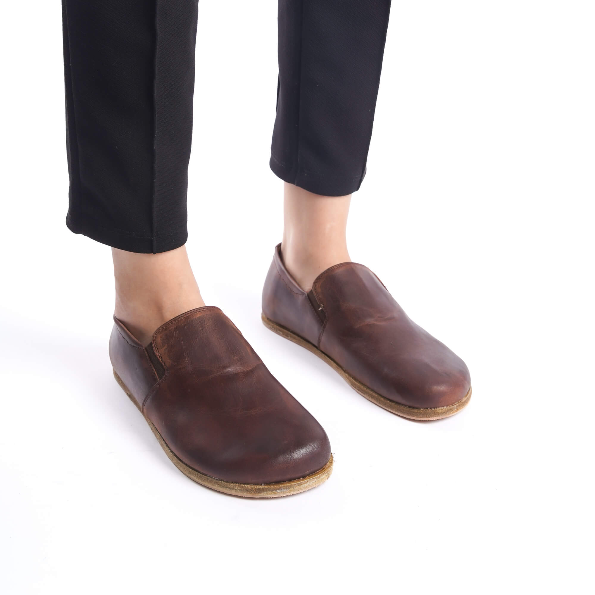 Front view of Ionia Leather Barefoot Women Loafers in brown, paired with black pants for a sleek look.