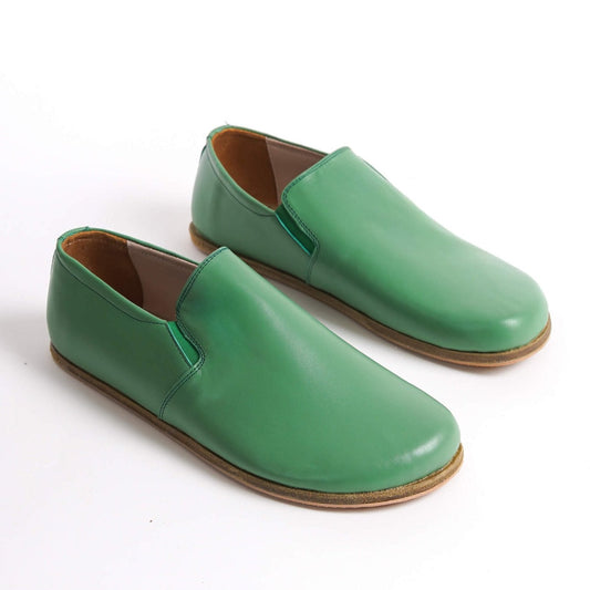 Green Ionia leather barefoot loafers with natural sole on white background. Shop now at pelanir.com!