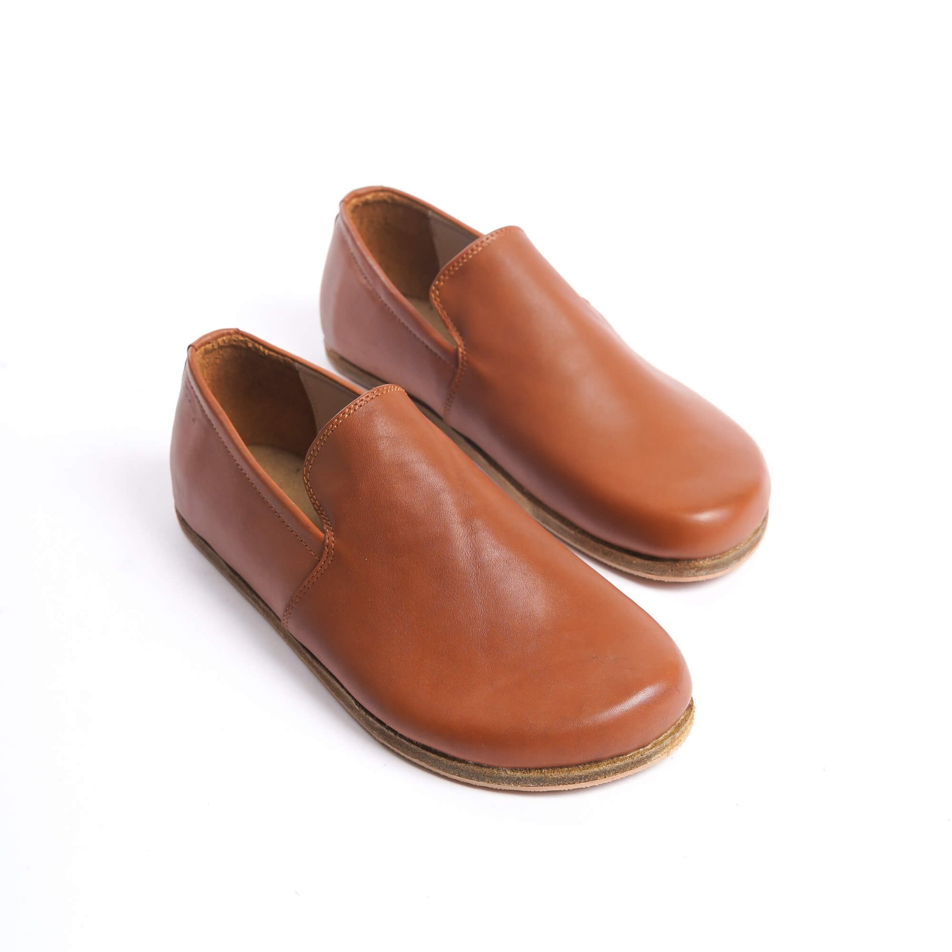 Aeolia tan brown leather barefoot women loafers, featuring a minimalist and comfortable design.