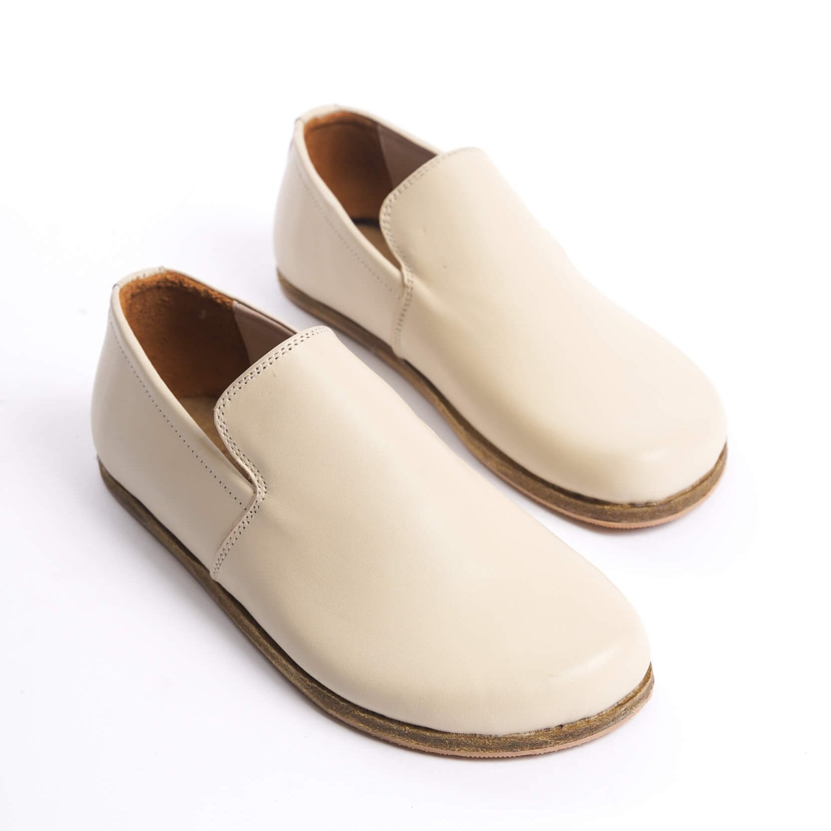 Pair of Aeolia Leather Barefoot Women Loafers in Beige - Top view highlighting the smooth genuine leather finish.