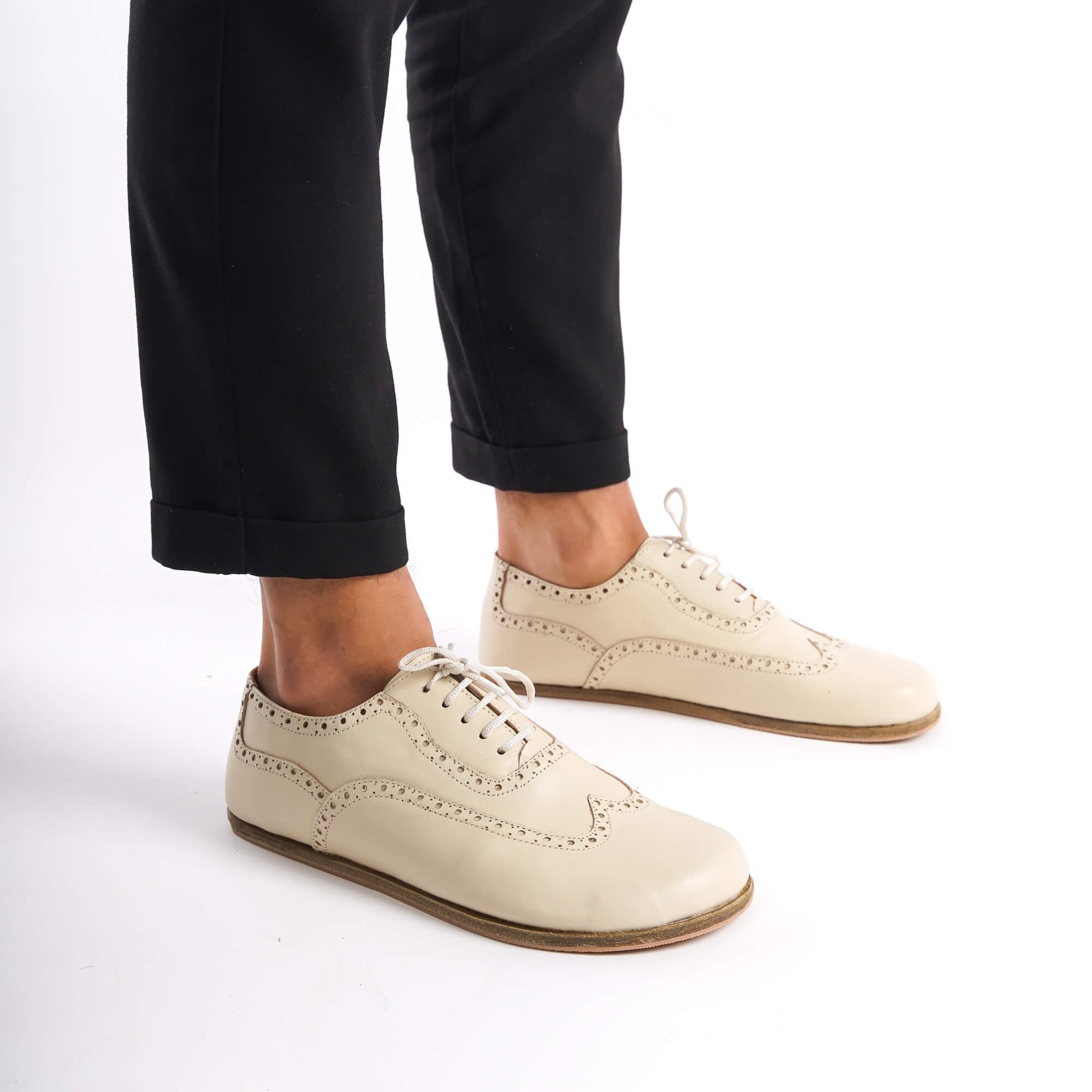 Close-up of beige Doris Leather Barefoot Men's Oxfords, featuring intricate brogue detailing and high-quality leather.