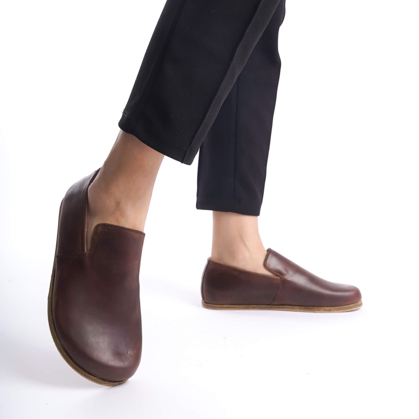 Model wearing black pants and Aeolia Brown Women Loafers, showcasing the shoe's elegant design and comfortable fit in motion.