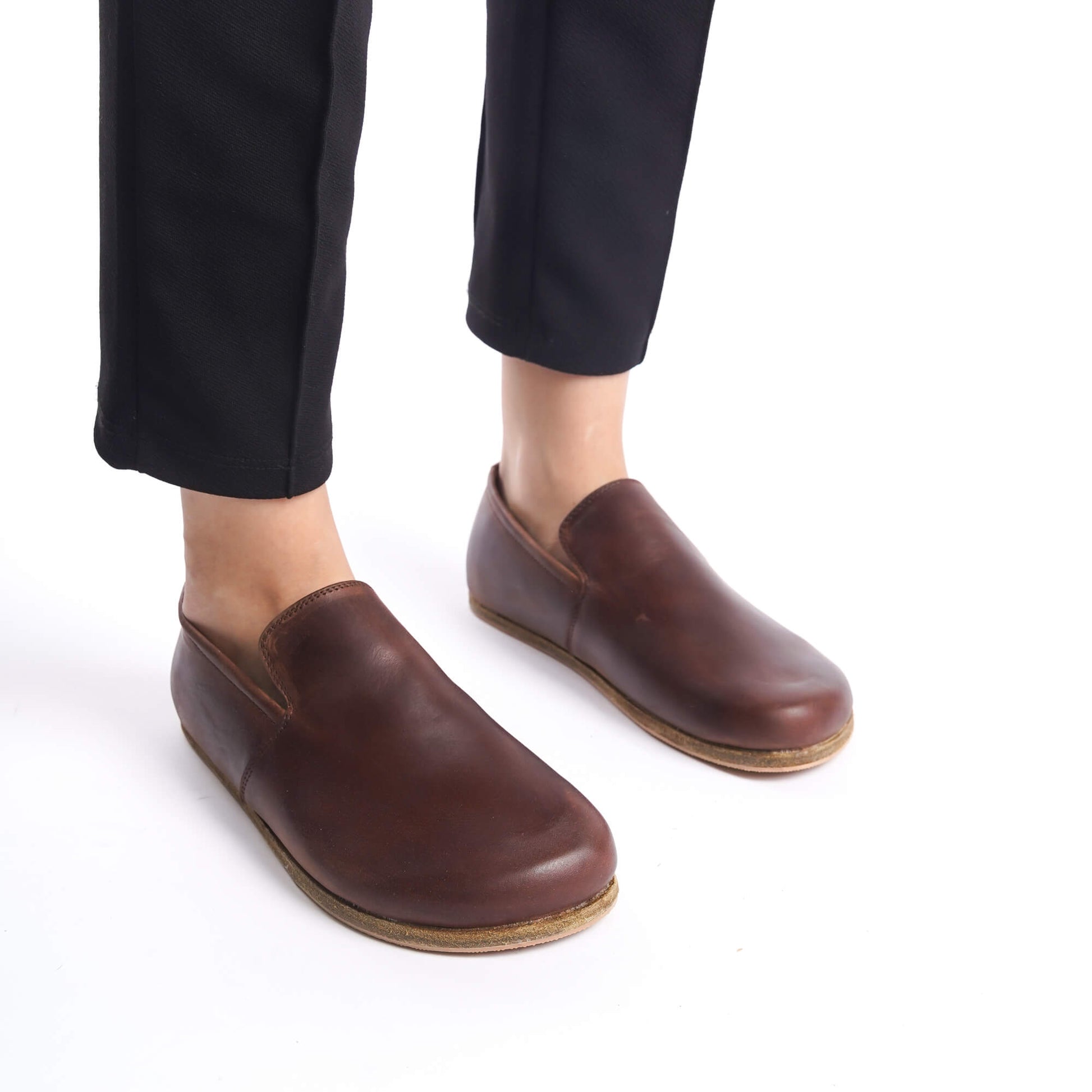 Model wearing Aeolia Brown Women Loafers with black pants, showcasing the loafer's minimalist design and comfortable fit.