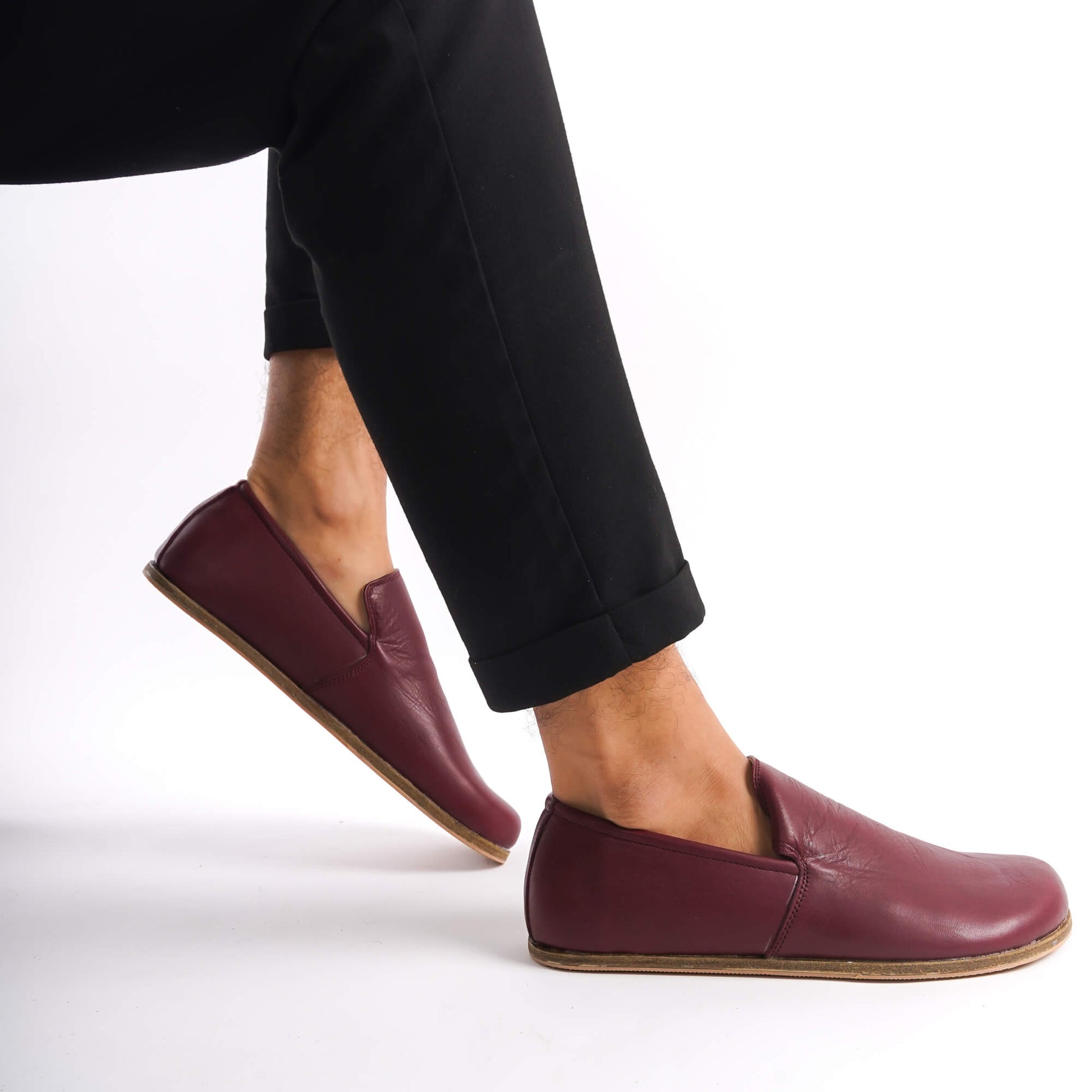 Man wearing burgundy Aeolia leather barefoot men's loafers with black pants. Experience premium comfort and style at pelanir.com!