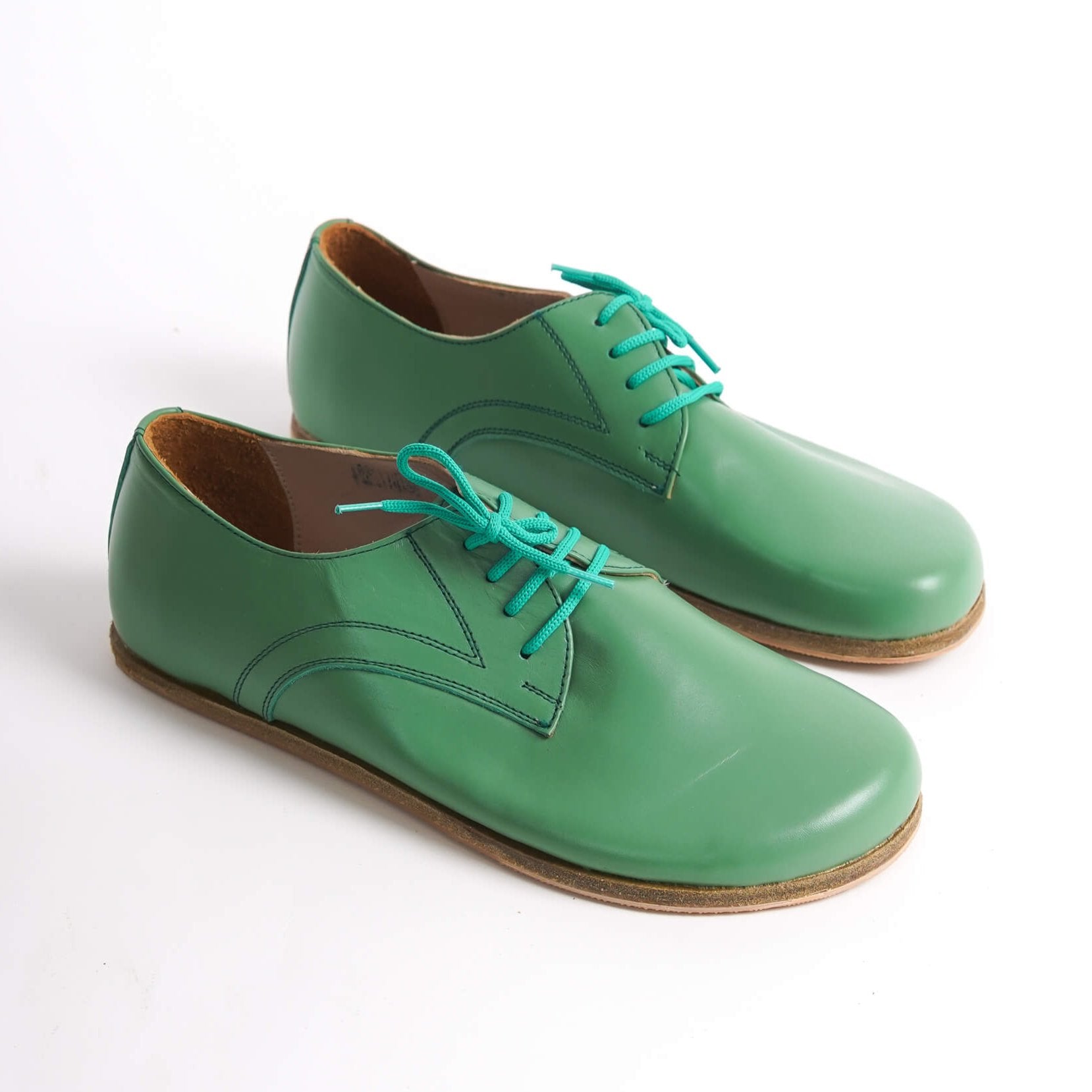 Locris Leather Barefoot Men's Oxfords in green, displayed side by side, highlighting their vibrant color and genuine leather.