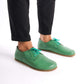 Model wearing Locris Leather Barefoot Men's Oxfords in green, demonstrating their lightweight and flexible construction.