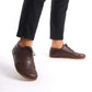 Brown Doris Leather Barefoot Men's Oxfords styled with black pants, perfect for both casual and formal wear.