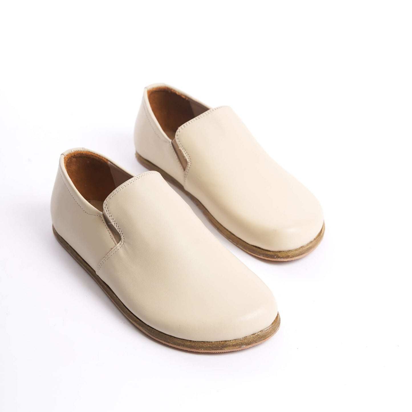 Close-up of Ionia beige loafers on white background - Discover comfort with Ionia Leather Barefoot Women Loafers in beige.