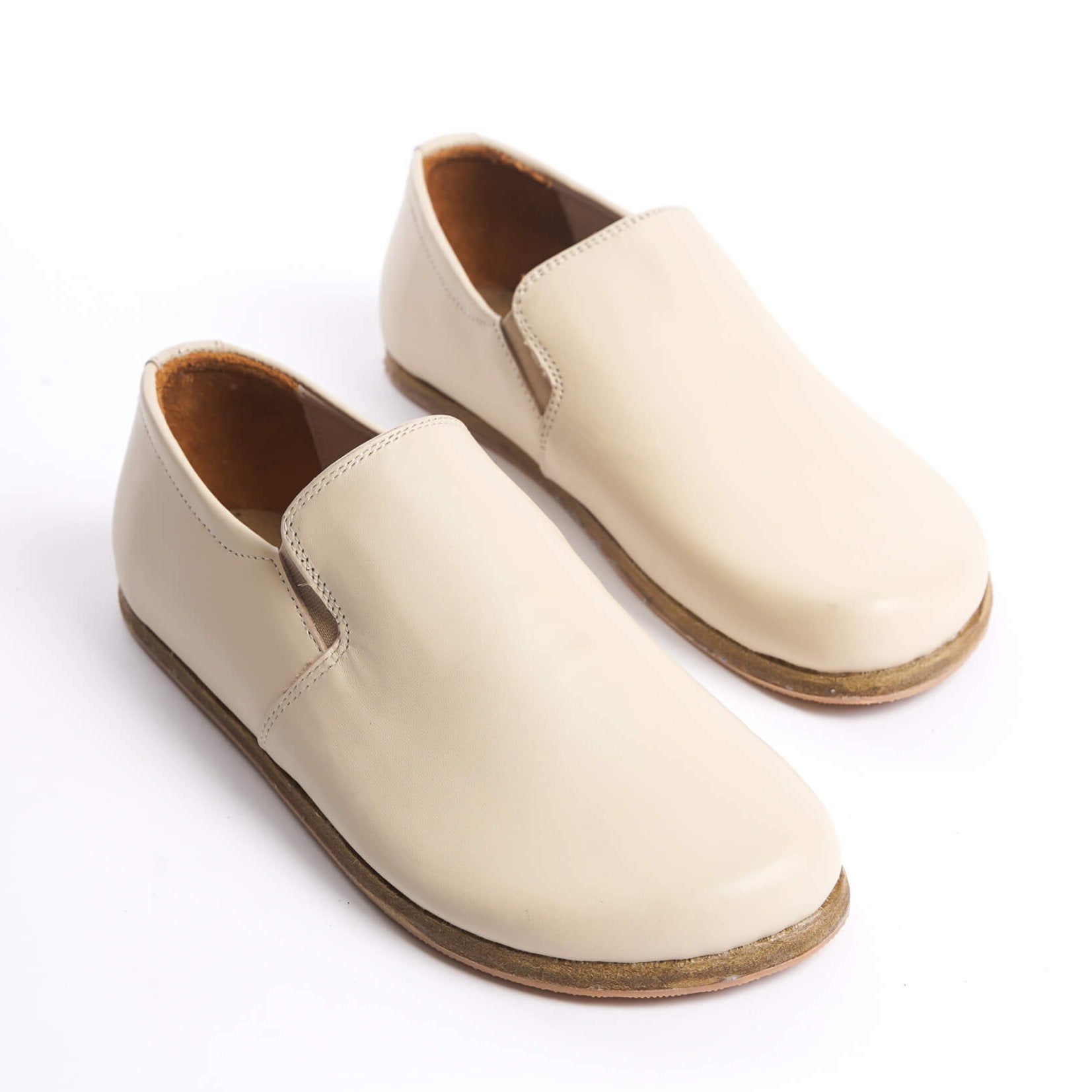 Close-up of Ionia beige loafers on white background - Discover comfort with Ionia Leather Barefoot Women Loafers in beige.