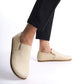 Ionia beige loafers showcased with black pants - Enjoy sleek design with Ionia Leather Barefoot Women Loafers in beige.