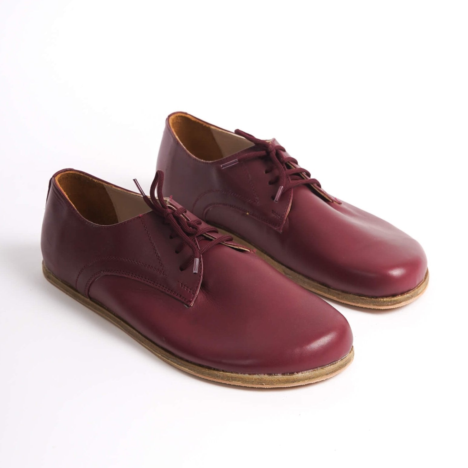 Locris Leather Barefoot Men's Oxfords in burgundy, displayed side by side, highlighting their rich color and genuine leather.