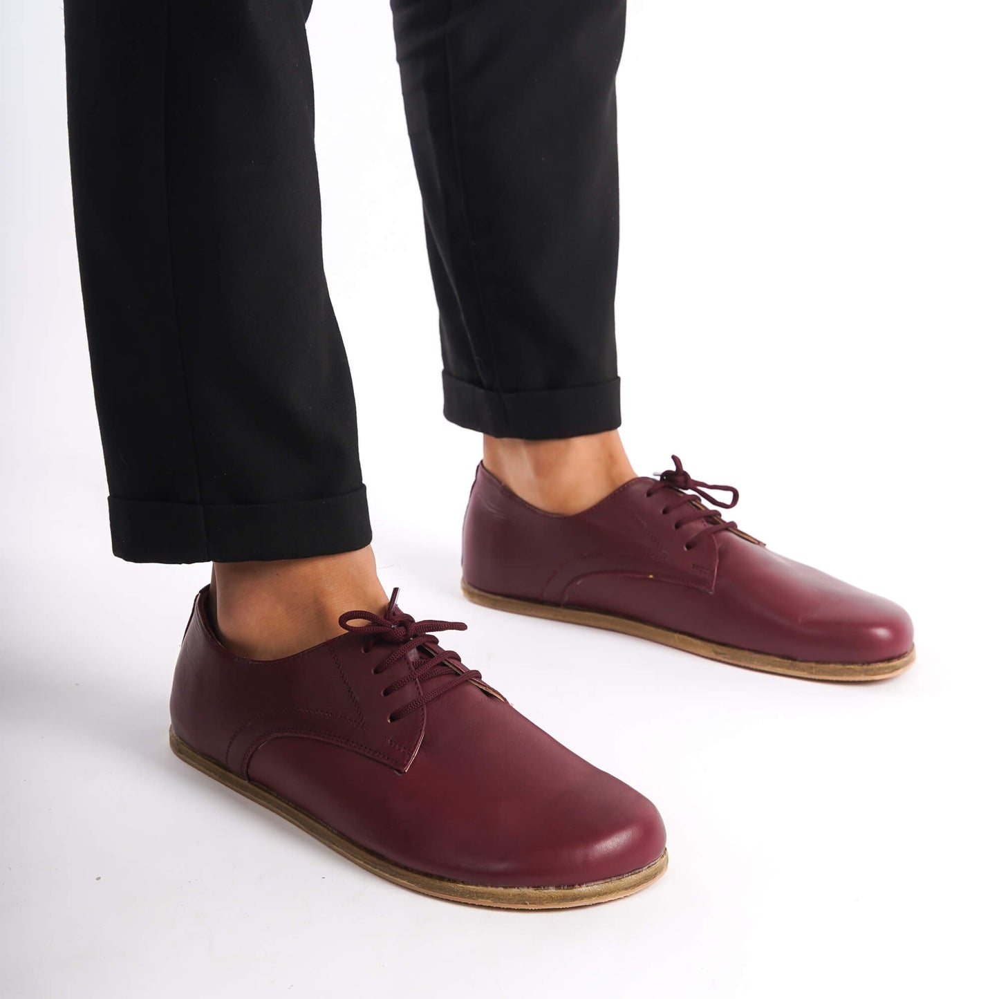 Top-down view of Locris Leather Barefoot Men's Oxfords in burgundy, paired with gray socks, highlighting their unique style.