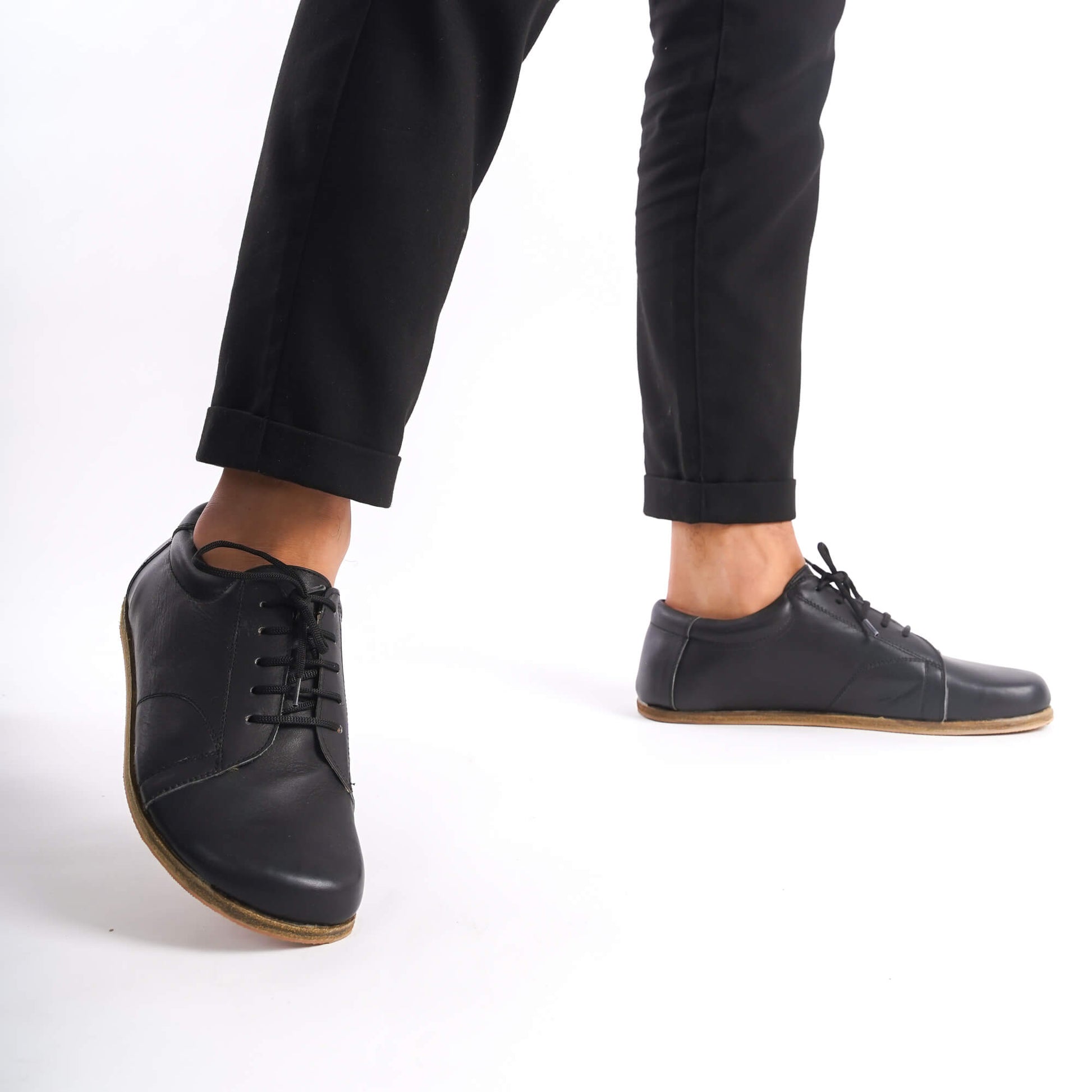 Black Lydia Leather Barefoot Men's Sneakers with lace-up closure, displayed with a focus on the craftsmanship and genuine leather material.