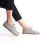 Side view of gray suede Locris Leather Barefoot Women Oxfords paired with black pants, highlighting their natural fit and flexibility.