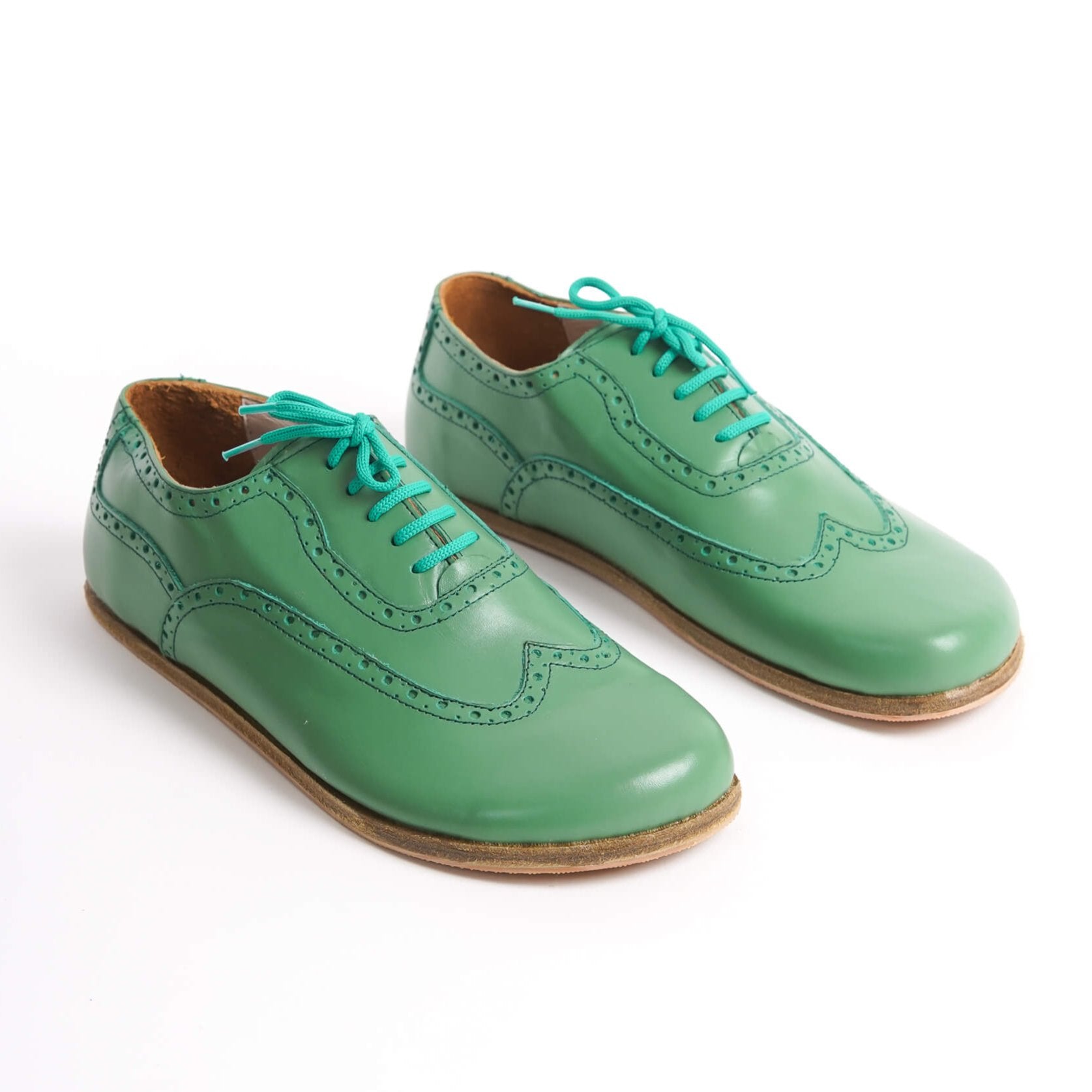 "Elegant green Doris Leather Barefoot Oxfords with brogue details for men – stylish and comfortable.