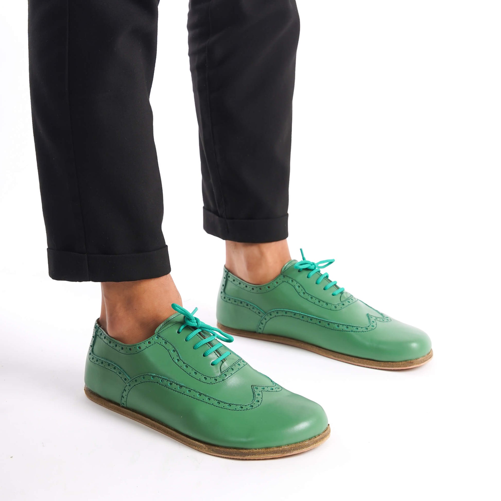Stylish green Doris barefoot Oxfords paired with beige pants – versatile, modern, and comfortable footwear.