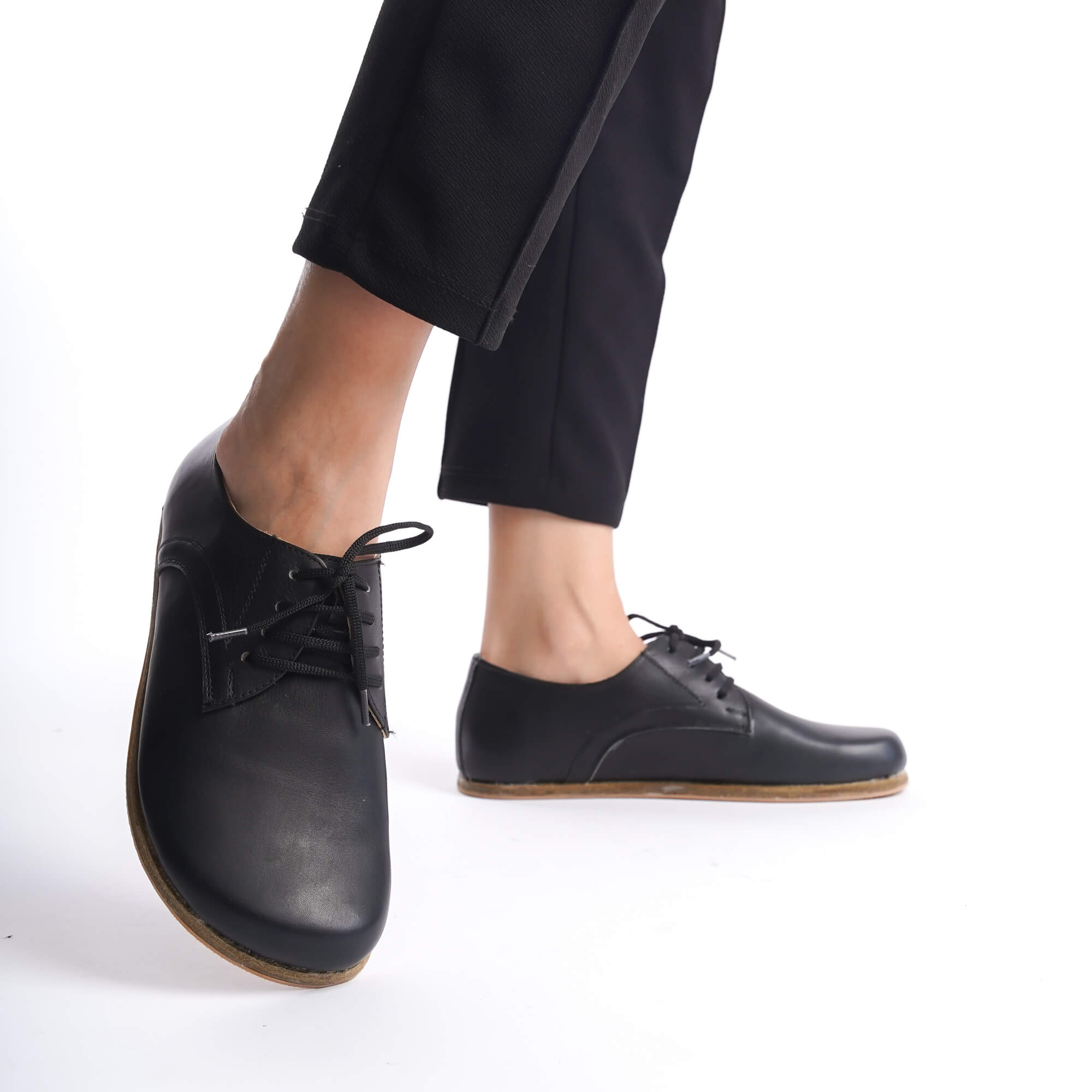 Black Locris Leather Barefoot Women Oxfords shown from a low angle, demonstrating the sleek design and comfortable fit for everyday wear.