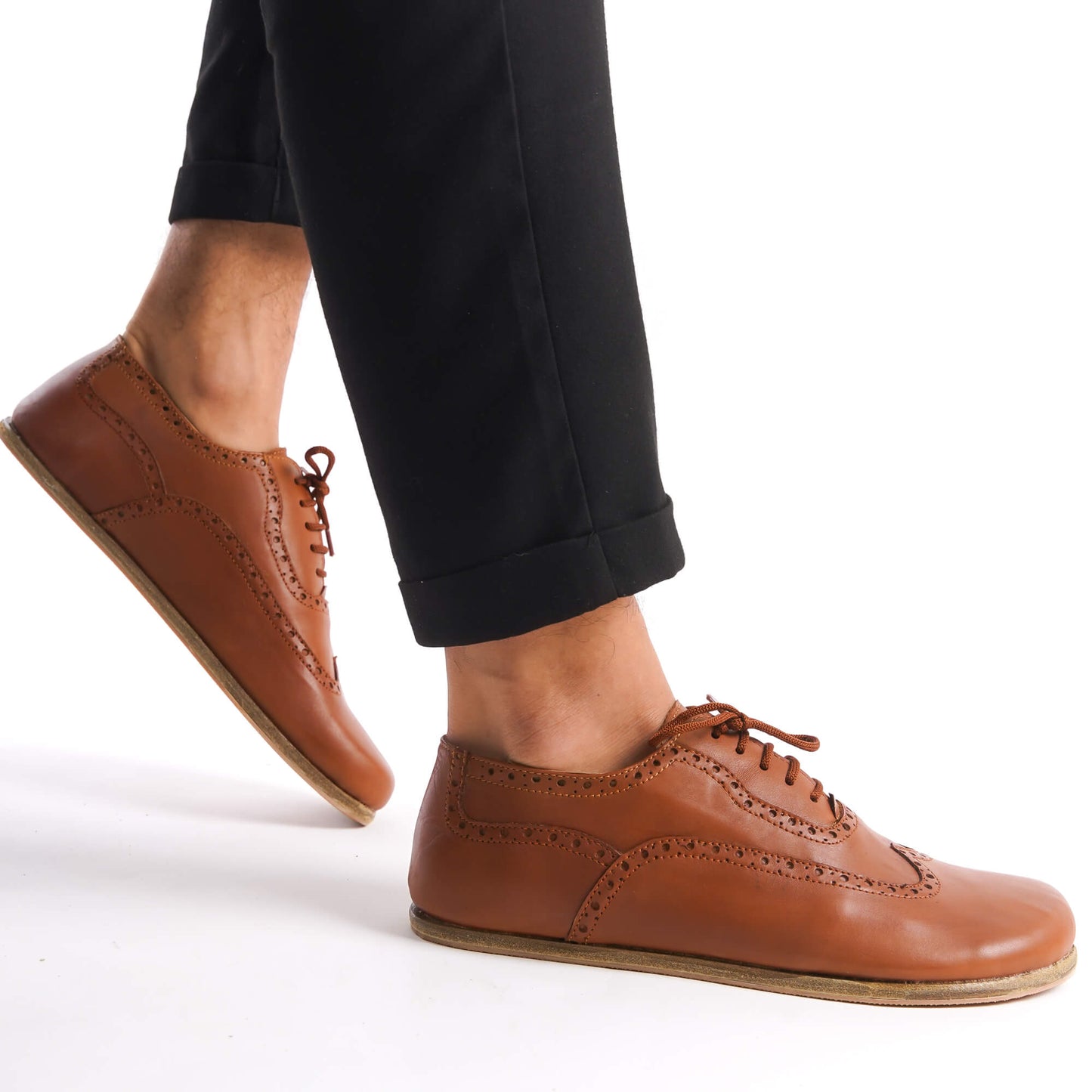 Close-up of tan brown Doris Leather Barefoot Oxfords showcasing brogue details and natural foot shape.