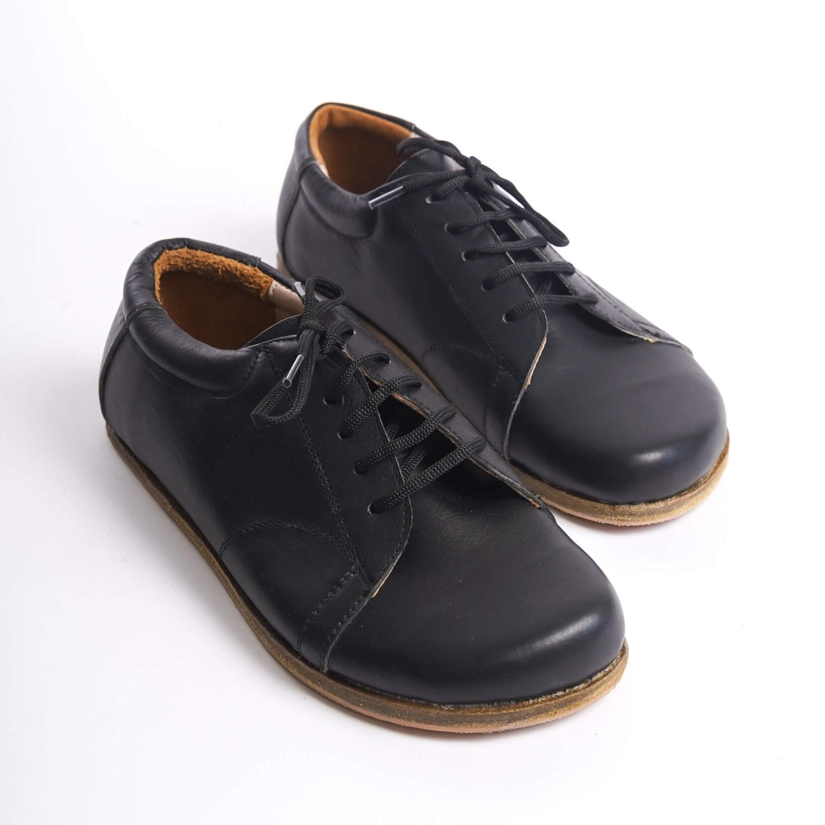Black Lydia Leather Barefoot Women's Sneakers, close-up showcasing the classic design and quality leather.