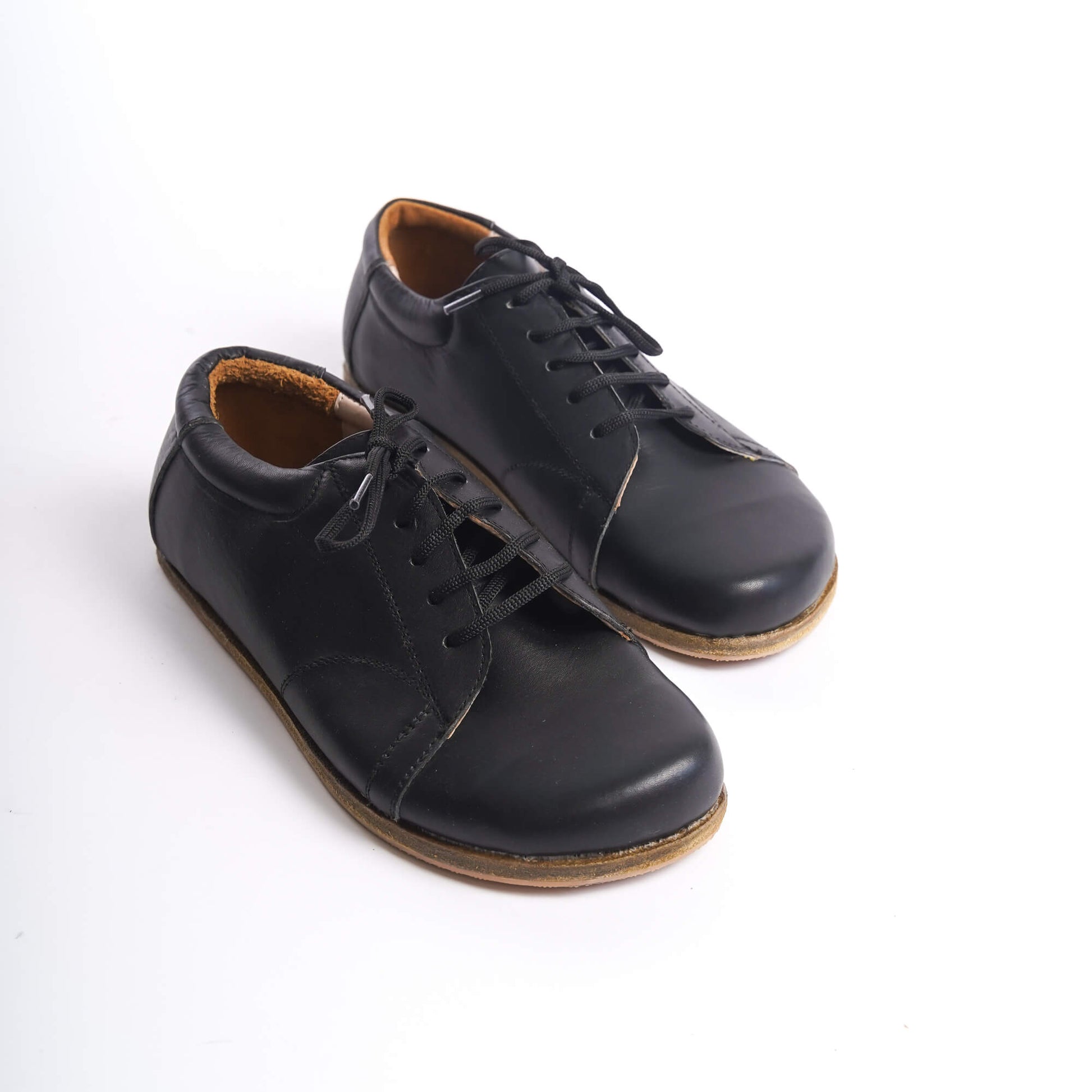 Black Lydia Leather Barefoot Women's Sneakers, close-up showcasing the classic design and quality leather.