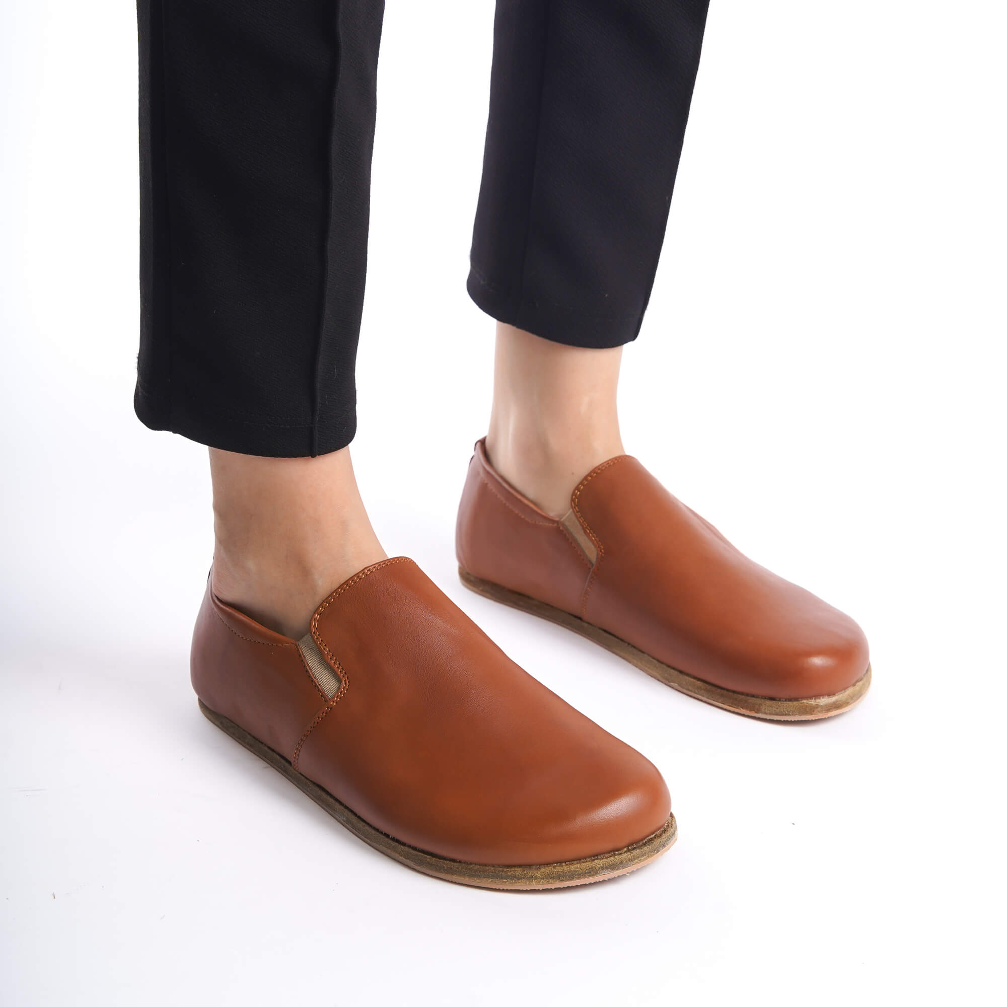 Detailed shot of tan brown Ionia leather barefoot women loafers, showcasing their elegant and minimalist design.