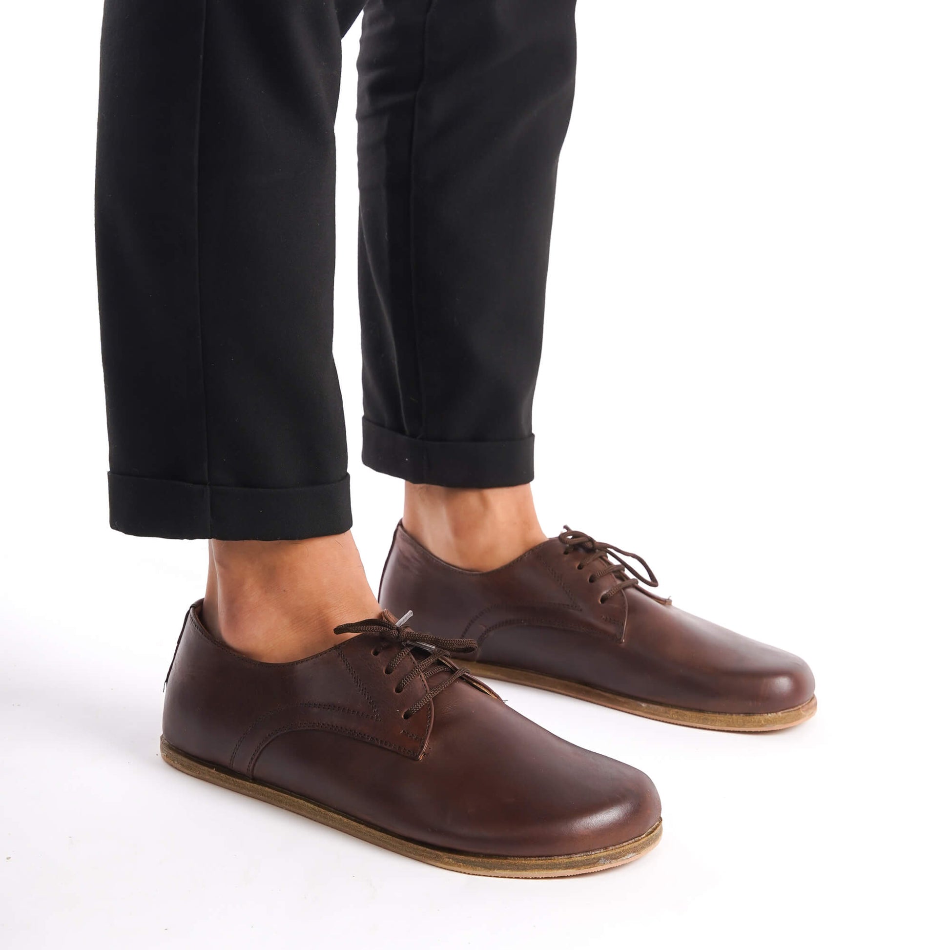 Locris Leather Barefoot Men's Oxfords in brown, worn by a model with black pants, perfect for a natural fit and foot health.