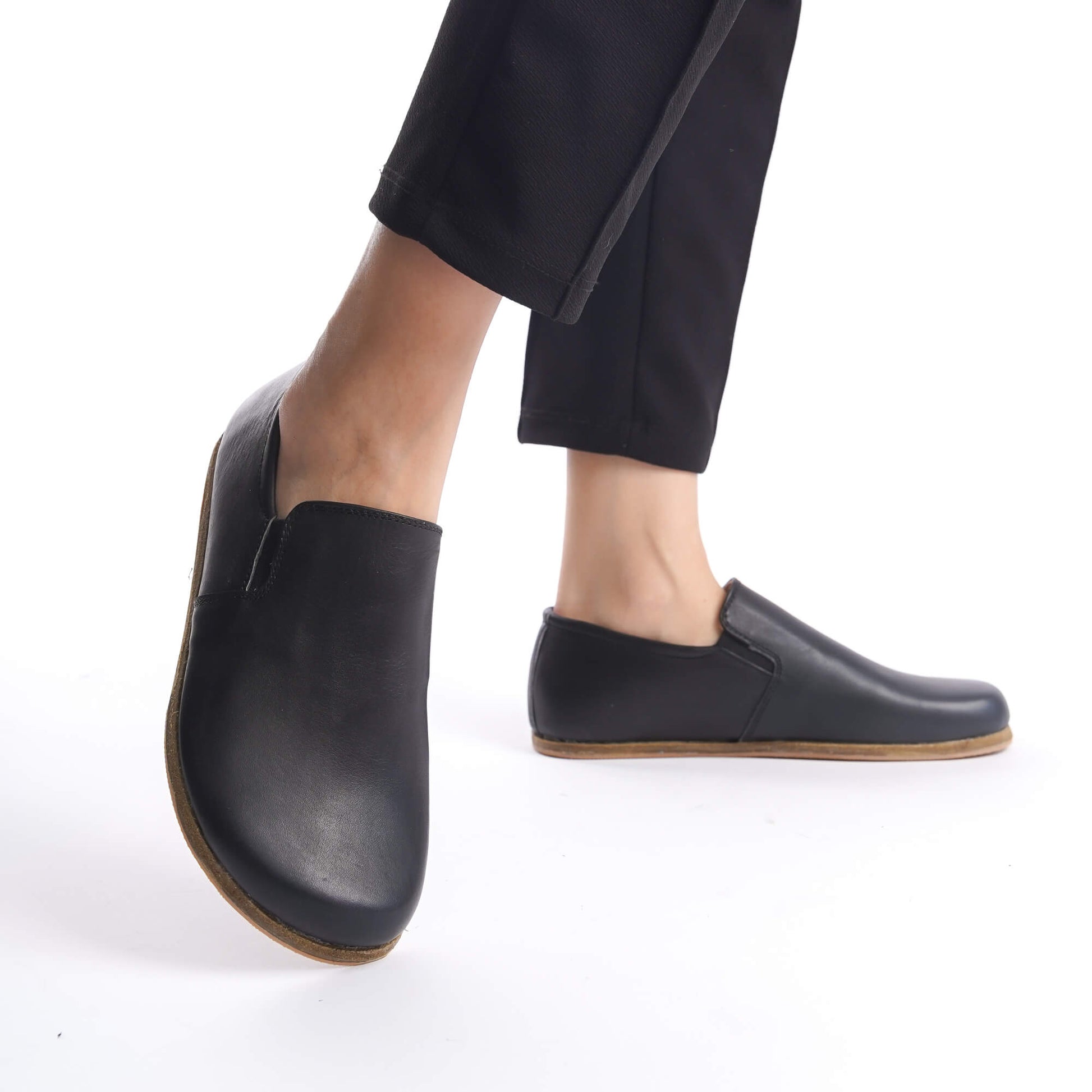Ionia Black Leather Loafers - Side Profile in Motion