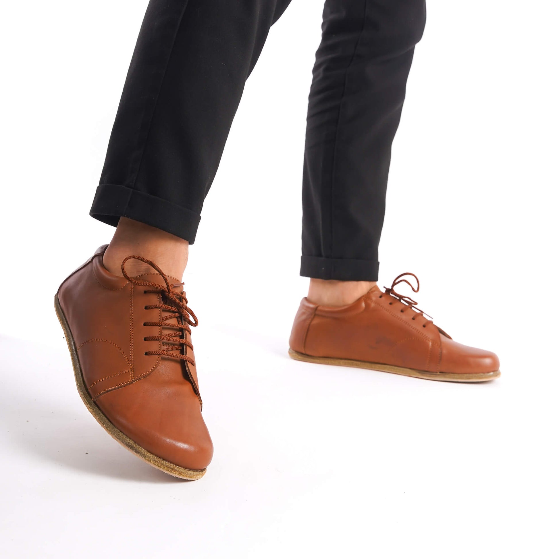 Close-up of tan brown Lydia Leather Barefoot Men's Sneakers, showcasing high-quality leather and minimalist design.