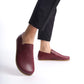 Ionia Burgundy loafers displayed with a helmet and gloves for a stylish look.