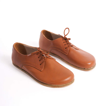 Locris Leather Barefoot Men's Oxfords in tan brown, displayed side by side, highlighting their rich color and genuine leather.