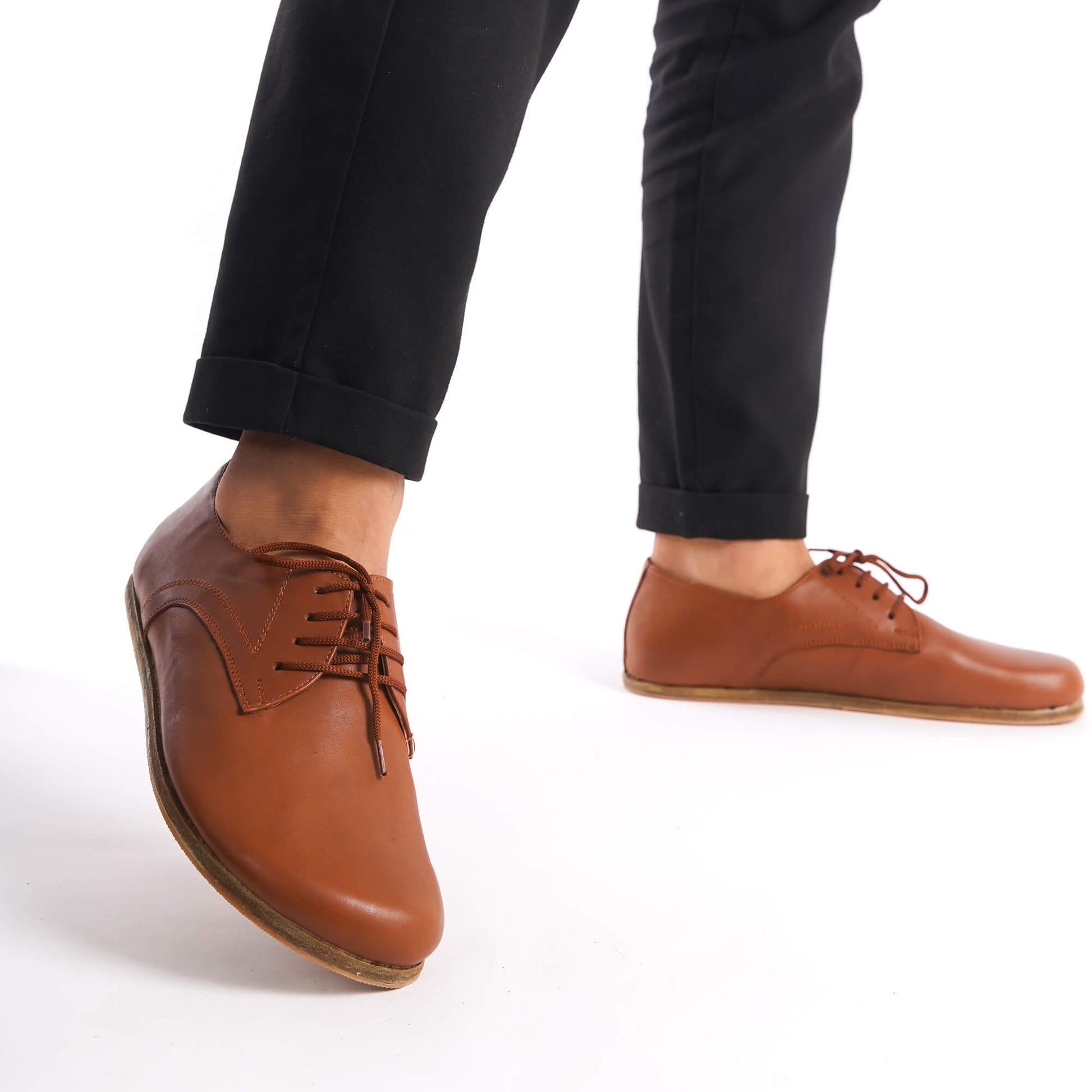 Walking shot of Locris Leather Barefoot Men's Oxfords in tan brown, highlighting their natural fit and foot health benefits.