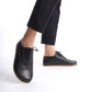 Model showcasing Doris Leather Barefoot Women's Oxfords in Black with detailed stitching, paired with black pants