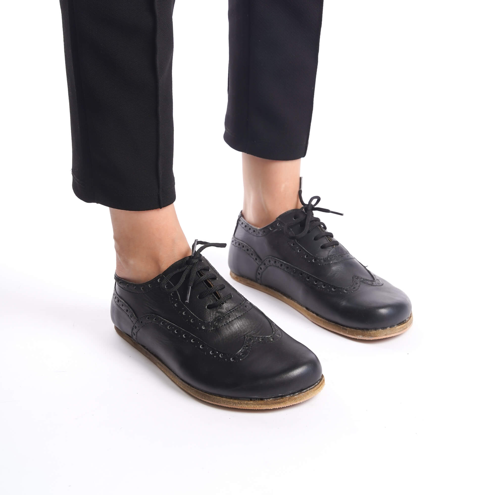 Close-up of black Doris Leather Barefoot Women Oxfords showcasing intricate brogue details, available at pelanir.com.